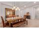 Bright dining room featuring wood table, bench seating, decorative lighting, and stylish flooring detail at 31107 N 27Th Ave, Phoenix, AZ 85085