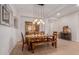 Charming dining room with wood table, bench seating, decorative lighting, and tile flooring detail at 31107 N 27Th Ave, Phoenix, AZ 85085