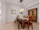 Stylish dining room with wood table, bench seating, decorative lighting, and elegant tile flooring detail at 31107 N 27Th Ave, Phoenix, AZ 85085
