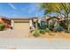 Inviting home featuring stone accents, desert landscaping, and a spacious two-car garage at 31107 N 27Th Ave, Phoenix, AZ 85085