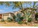 Front exterior featuring desert landscaping, stone accents, and a two-car garage, surrounded by nature at 31107 N 27Th Ave, Phoenix, AZ 85085