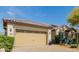 Close-up of a two-car garage and desert landscaping, showing details of the home's facade at 31107 N 27Th Ave, Phoenix, AZ 85085
