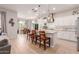 Open-concept kitchen with white cabinetry, stainless steel appliances, bar seating, and adjacent breakfast nook at 31107 N 27Th Ave, Phoenix, AZ 85085