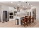 Modern kitchen features white cabinets, stainless appliances, kitchen island, and adjacent wine fridge at 31107 N 27Th Ave, Phoenix, AZ 85085