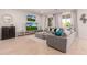 Bright living room features neutral tones, tile floors, large windows with curtains, and comfortable seating at 31107 N 27Th Ave, Phoenix, AZ 85085