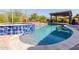Beautiful pool and spa with blue tiling, a tanning ledge, and desert landscaping at 31107 N 27Th Ave, Phoenix, AZ 85085