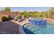 Backyard pool and spa featuring stone deck, stylish seating, and desert landscaping at 31107 N 27Th Ave, Phoenix, AZ 85085
