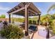 Relaxing poolside patio area featuring a covered seating area and lush landscaping at 31107 N 27Th Ave, Phoenix, AZ 85085