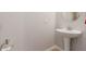 This powder room has a pedestal sink with neutral walls at 31107 N 27Th Ave, Phoenix, AZ 85085