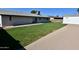 Spacious backyard featuring a green lawn, garage, and large gravel area, perfect for outdoor living at 3310 W Sweetwater Ave, Phoenix, AZ 85029