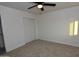 Neutral bedroom features carpet, a closet and ceiling fan at 3310 W Sweetwater Ave, Phoenix, AZ 85029