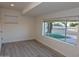 This bedroom is finished with wood laminate flooring, fresh paint, and bright lighting at 3310 W Sweetwater Ave, Phoenix, AZ 85029