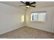 Neutral bedroom with updated ceiling fan and a bright window view to the backyard at 3310 W Sweetwater Ave, Phoenix, AZ 85029