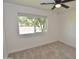 Bright bedroom featuring neutral carpet, ceiling fan and a view from the window at 3310 W Sweetwater Ave, Phoenix, AZ 85029