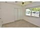 Bedroom showcasing plush carpeting, ample closet space, and natural light from the exterior view window at 3310 W Sweetwater Ave, Phoenix, AZ 85029