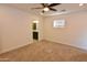 Bedroom with carpet flooring and a ceiling fan, offering a glimpse into the adjacent bathroom at 3310 W Sweetwater Ave, Phoenix, AZ 85029