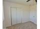 Bedroom with neutral carpet, a double-door closet, and a bright window at 3310 W Sweetwater Ave, Phoenix, AZ 85029