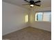 Neutral bedroom features carpet, a window and ceiling fan at 3310 W Sweetwater Ave, Phoenix, AZ 85029