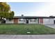 Charming single-story home with solar panels and a well-manicured lawn at 3310 W Sweetwater Ave, Phoenix, AZ 85029