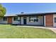Charming single-story home with a well-maintained front lawn, solar panels, and stylish exterior accents at 3310 W Sweetwater Ave, Phoenix, AZ 85029