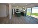 Bright kitchen with stainless steel appliances, a central island, and access to outdoor space at 3310 W Sweetwater Ave, Phoenix, AZ 85029