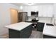 Stunning kitchen features an island, stainless steel appliances, and modern lighting at 3310 W Sweetwater Ave, Phoenix, AZ 85029
