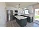 Beautifully renovated kitchen with stainless steel appliances, stylish island, and ample cabinet space at 3310 W Sweetwater Ave, Phoenix, AZ 85029