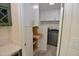 Updated laundry room including pull out drawer storage, washer, and dryer at 3310 W Sweetwater Ave, Phoenix, AZ 85029