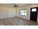 Bright living room featuring sleek, light-colored flooring, fresh paint, and a ceiling fan at 3310 W Sweetwater Ave, Phoenix, AZ 85029