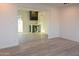 Open-concept living space with modern vinyl floors, complemented by a stylish bar area at 3310 W Sweetwater Ave, Phoenix, AZ 85029