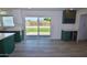 Living area with a sliding door to a yard and view to the kitchen with modern cabinetry at 3310 W Sweetwater Ave, Phoenix, AZ 85029