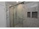 Marble tiled shower with glass door and mosaic tiled floor at 3310 W Sweetwater Ave, Phoenix, AZ 85029