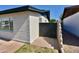 A secure side yard featuring a solid gate and lush lawn, blending privacy and outdoor living at 3310 W Sweetwater Ave, Phoenix, AZ 85029