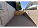 View of the side yard featuring a wooden gate between two buildings, creating a private and secure space at 3310 W Sweetwater Ave, Phoenix, AZ 85029