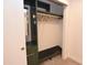 Walk-in closet features shelving, a bench, and hangers at 3310 W Sweetwater Ave, Phoenix, AZ 85029