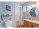 Bathroom featuring marble countertops, toilet, window, and decorative wall art at 3408 W Carol Ave, Phoenix, AZ 85051