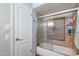 A well-maintained bathroom offering mosaic tiling around the bathtub and glass doors at 3408 W Carol Ave, Phoenix, AZ 85051