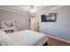 Comfortable bedroom featuring ceiling fan, vanity area, and bright natural light at 3408 W Carol Ave, Phoenix, AZ 85051