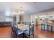 Spacious dining area featuring an open layout, wood floors, and a view into the kitchen at 3408 W Carol Ave, Phoenix, AZ 85051