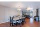 Open-concept living space with dining area, wood floors, and a cozy fireplace feature at 3408 W Carol Ave, Phoenix, AZ 85051