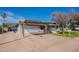 Single-story home features an attached garage, spacious driveway, and low maintenance landscaping at 3408 W Carol Ave, Phoenix, AZ 85051