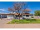 Single-story home with covered parking, desert landscaping, and appealing curb appeal at 3408 W Carol Ave, Phoenix, AZ 85051