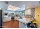 Bright, updated kitchen with granite countertops, stainless appliances, and breakfast bar at 3408 W Carol Ave, Phoenix, AZ 85051
