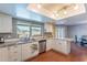 Updated kitchen features white cabinetry, tile backsplash, and stainless steel dishwasher at 3408 W Carol Ave, Phoenix, AZ 85051