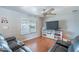 Bright living room with large windows, hardwood floors, and media console at 3408 W Carol Ave, Phoenix, AZ 85051