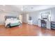 A stylish main bedroom with a comfortable bed, vanity and ensuite bathroom at 3408 W Carol Ave, Phoenix, AZ 85051