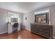 Main bedroom offering a vanity mirror with accent lighting and hardwood flooring at 3408 W Carol Ave, Phoenix, AZ 85051