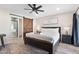 Comfortable bedroom featuring a barn door leading to a modern shower at 3615 E Charter Oak Rd, Phoenix, AZ 85032
