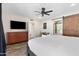 Bright bedroom with ceiling fan, barn door, and closet at 3615 E Charter Oak Rd, Phoenix, AZ 85032