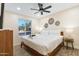 Comfortable bedroom featuring a ceiling fan, a cozy bed, and lots of natural light at 3615 E Charter Oak Rd, Phoenix, AZ 85032